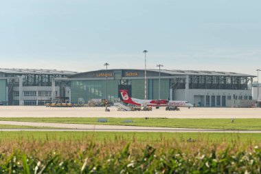 AirBerlin plane in front of Lufthansa hangar at Stuttgart airport clipart