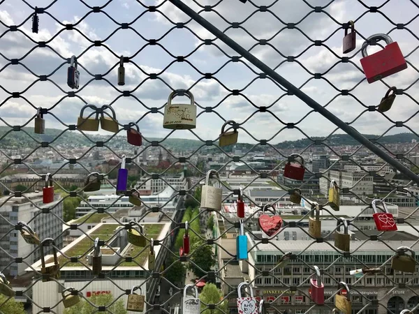 Locks of lovers high above the city — Stock Photo, Image