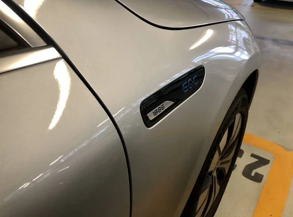 A silver Mercedes-Benz EQC 1886 special edition car is parked in a parking garage in Stuttgart — Stock Photo, Image