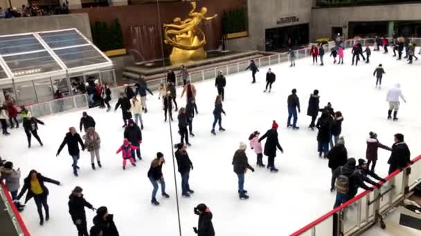 Gente disfrutando de Rockefeller Center Patinaje sobre hielo en Navidad con el famoso árbol de Navidad en la ciudad de Nueva York — Vídeos de Stock