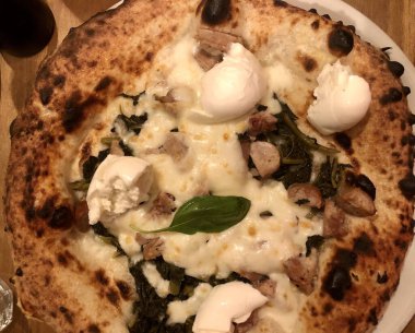 Mozzarella peynirli rustik italyan pizzası, salsiccia sosisi ve fesleğen yaprağı.