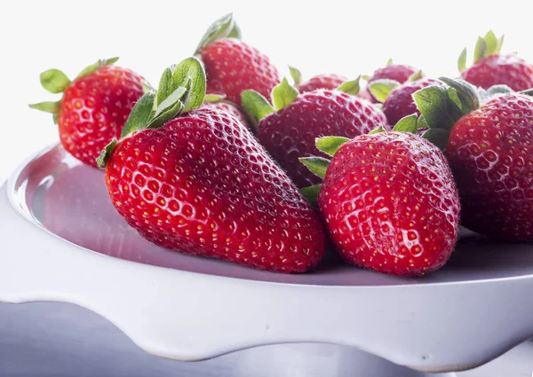 Strawberries over white stand — Stock Photo, Image