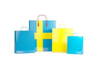 İsveç bayrağı üzerinde alışveriş torbaları