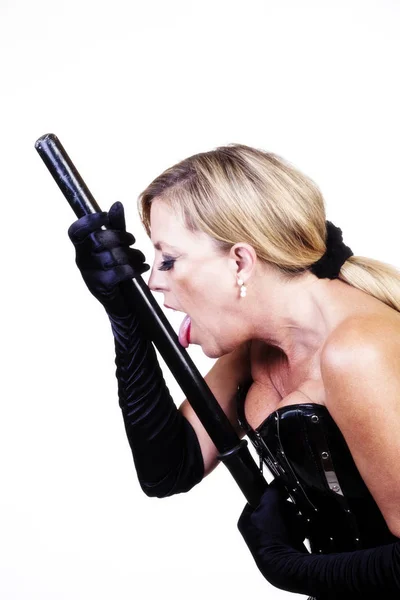 Older Blond Caucasian Woman Licking Black Baton — Stock Photo, Image