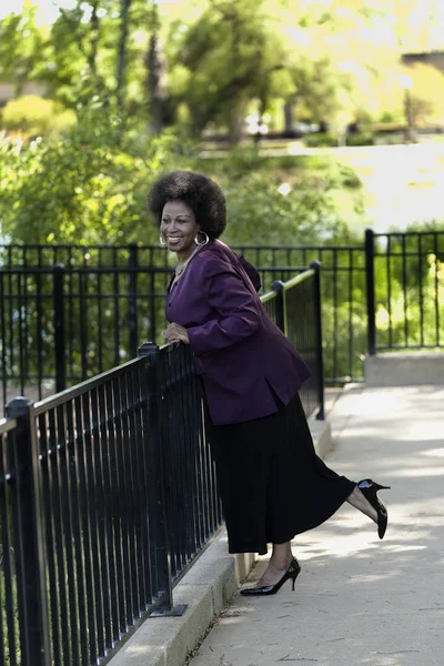 Older African American Woman Standing In Skirt And Purple Coat — Stock Photo, Image