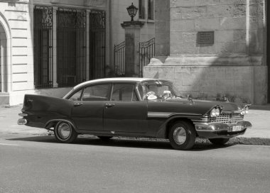 Havana, Cuba - Feb 10, 2019: Vintage classic American cars in restored condition - provide transport for tourism. clipart