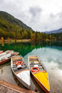 Alpine landscape and colorful boats, Lake Fusine,Italy clipart