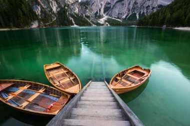 Boats on the Braies Lake ( Pragser Wildsee ) in Dolomites mounta clipart
