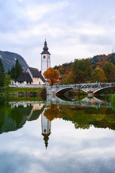 Church tower and stone bridge at Lake Bohinj — Stock Photo, Image