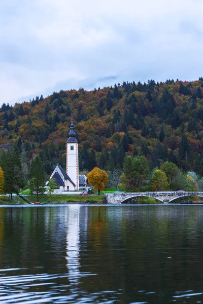 Church tower and stone bridge at Lake Bohinj — Stock Photo, Image