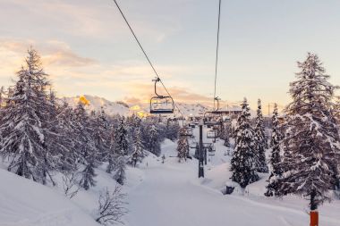 Winter mountains panorama with ski slopes and ski lifts clipart