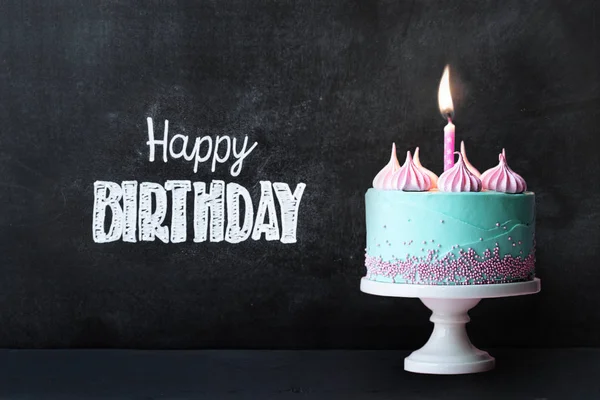 Birthday cupcake against chalkboard — Stock Photo, Image