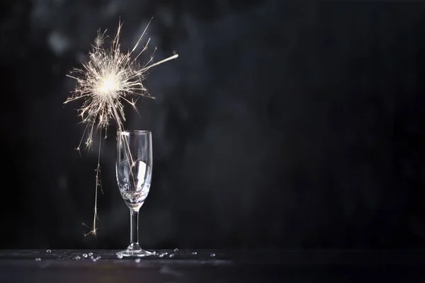 Champagne glass and sparkler — Stock Photo, Image