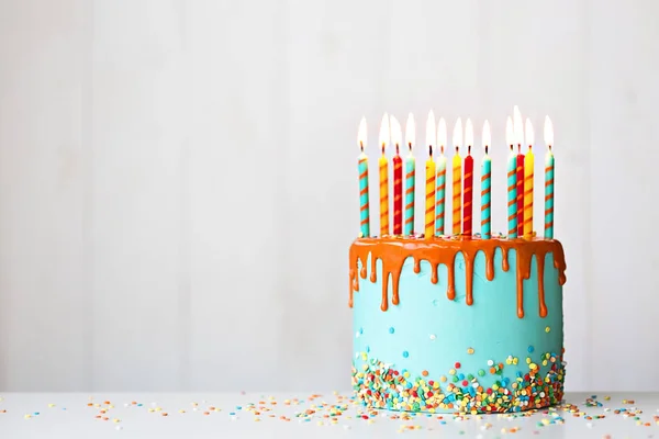 Birthday cake with candles and drip icing — Stock Photo, Image