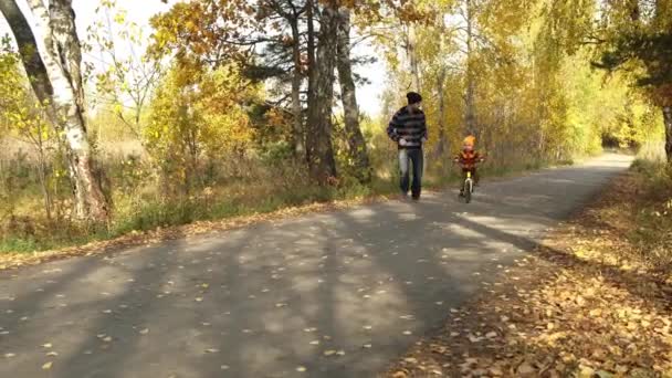 Padre Enseña Hijo Montar Bicicleta Parque Otoño Felices Momentos Familiares — Vídeos de Stock