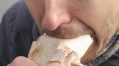 Yavaş çekimde sakallı adam Doner kebap, falafel shawarma ya da dışarıda tortilla sandviçi yiyor. Vejetaryen fast food. 
