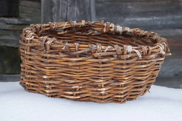 Old basket on snow — Stock Photo, Image