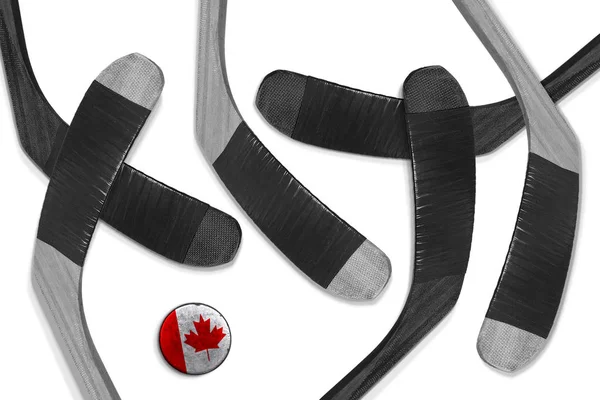 Canadian puck and hockey sticks — Stock Photo, Image