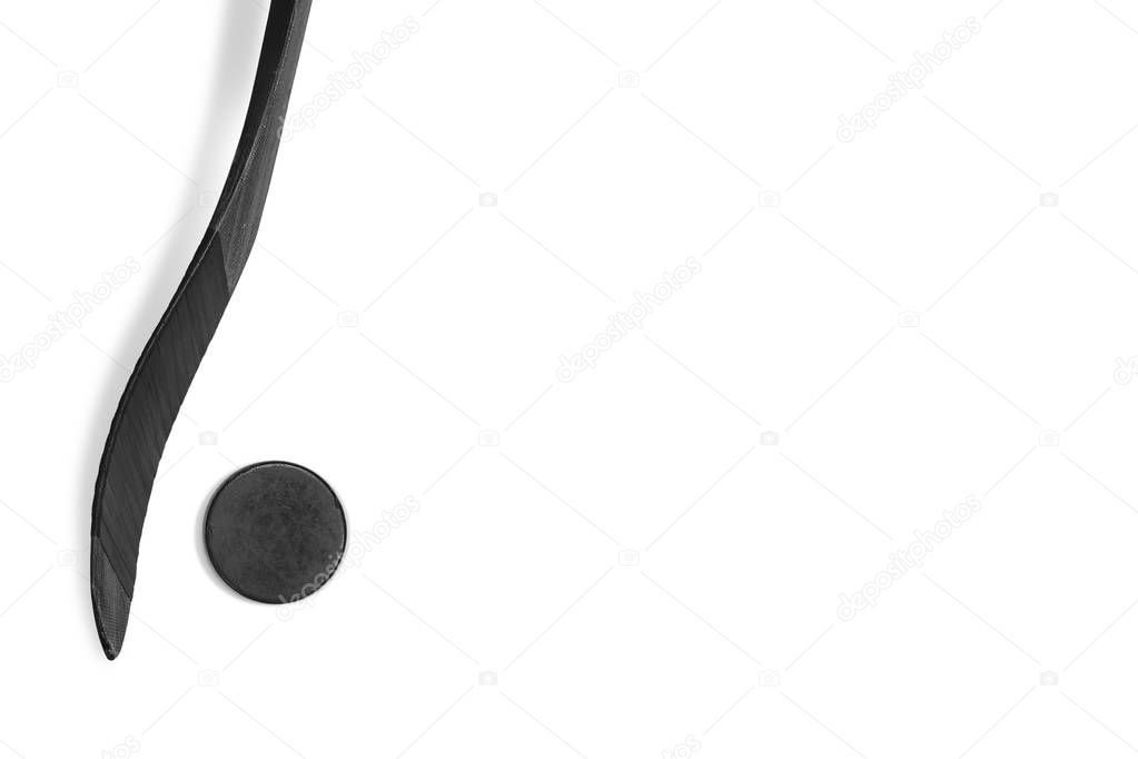 Hockey puck and stick on white background