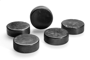 Hockey pucks on a white background clipart