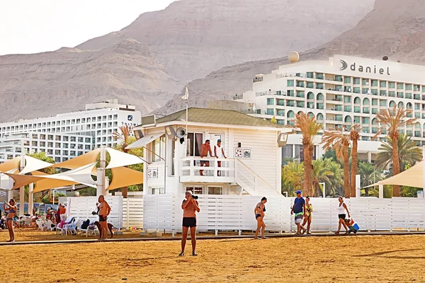 Férias e turistas descansam no resort Mar Morto no fundo de hotéis de luxo em Ein Bokek, Mar Morto, Israel — Fotografia de Stock