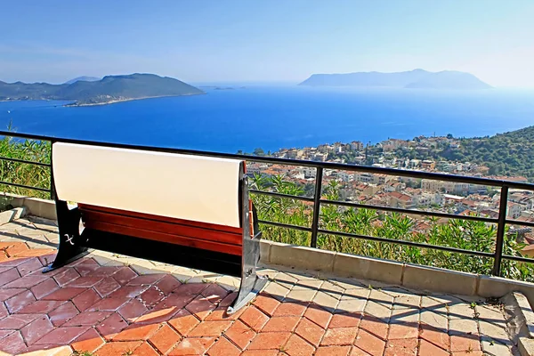 Bench and view of harbour of city Kas in Turkey and Greek island Kastelorizo — Stock Photo, Image