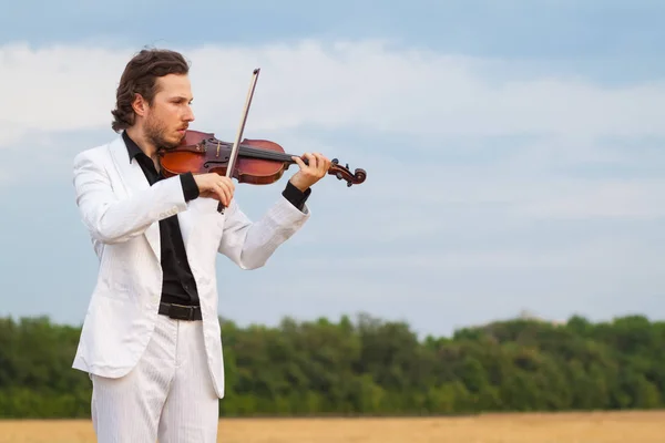 Professional violinist playing the violin outdoors