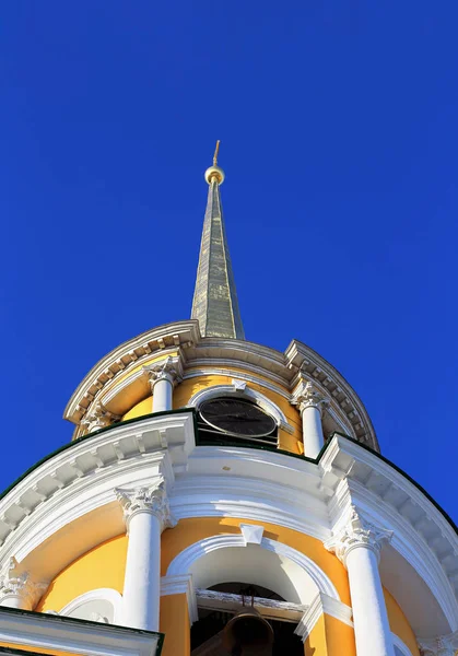 Bell tower with a spire and cross — Stock Photo, Image