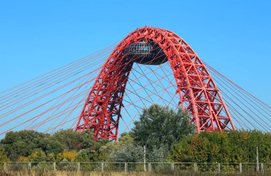 MOSCOW, RUSSIA  - SEPTEMBER 21: Zhivopisny Bridge - cable-stayed bridge with a pylon in the form of a red hinged arch, an observation deck and multiple ropes - on September 21, 2014 in Moscow