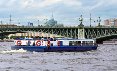 SAINT PETERSBURG, RUSSIA - JULY 13: Pleasure boat on the Neva river on a summer day - on July 13, 2019 in Saint Petersburg, Russia