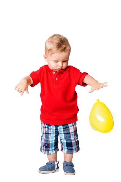 Baby boy with a yellow balloon — Stock Photo, Image