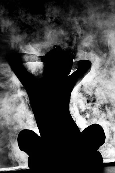 Girl stretching silhouette with smoke — Stock Photo, Image