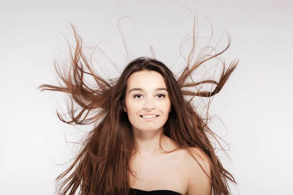 Beautiful brunette girl with windy hair — Stock Photo, Image
