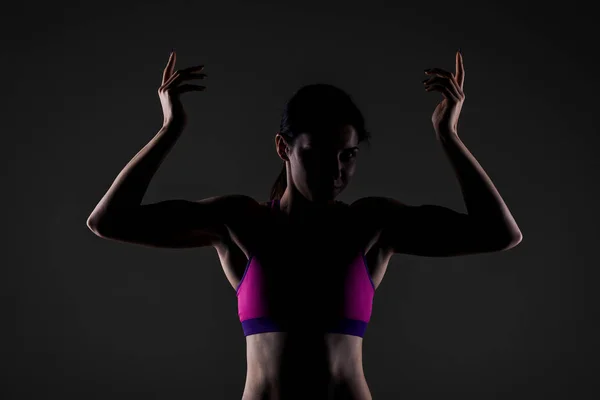 Muscular fitness girl silhouette — Stock Photo, Image
