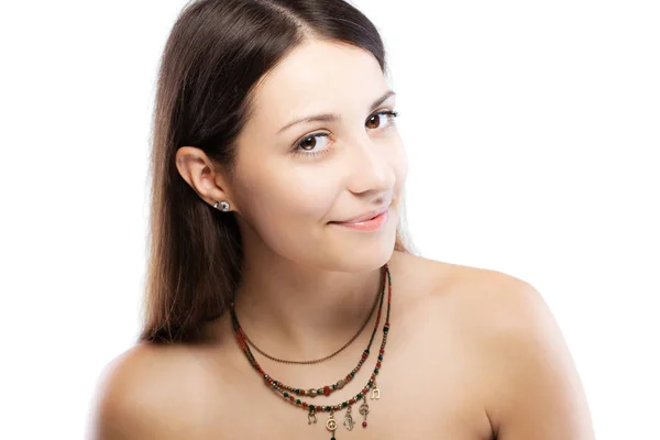 Surprised brunette girl wearing a necklace with generic symbols Stock Photo