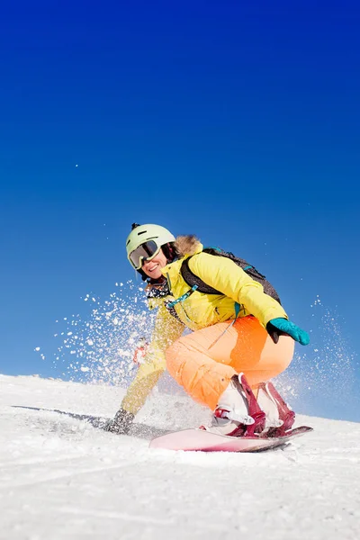 Snowboarded girl jumping on the snow — Stock Photo, Image