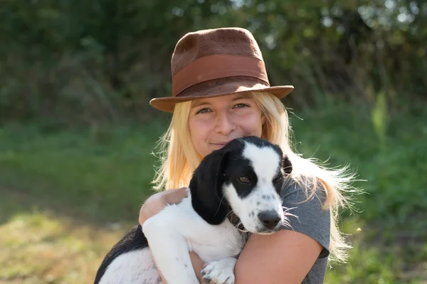 Woman with cute puppy playing — Stock Photo, Image