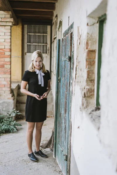 Gruselige blonde Frau in der Nähe der alten Tür — Stockfoto