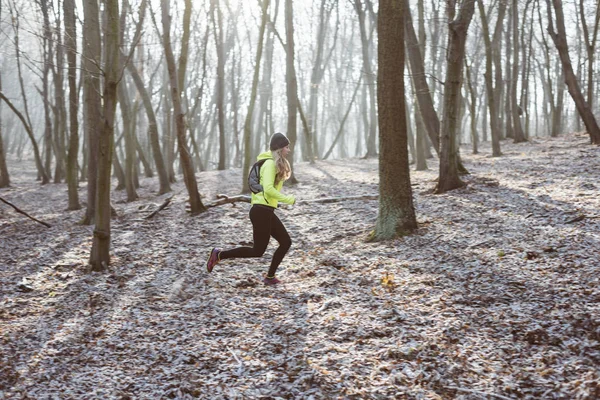 Active woman running in forest