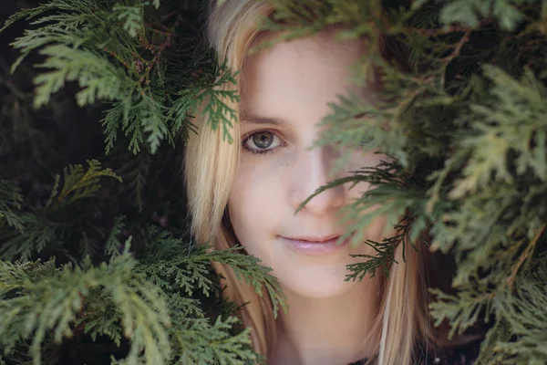 Cute young adult female hiding in forest, close up woman portrait — Stock Photo, Image