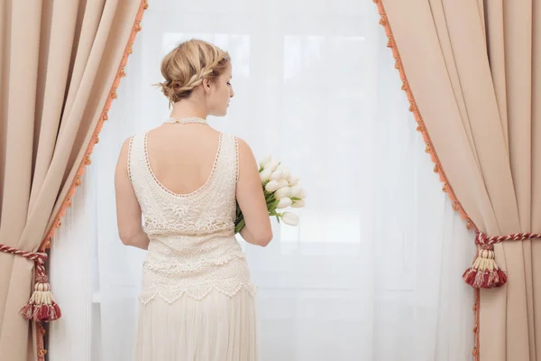 Bride in hotel room standing by the window — Stock Photo, Image