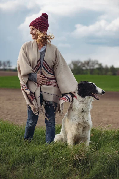 Mulher nova na moda com seu cão Borzoi posando ao ar livre . — Fotografia de Stock