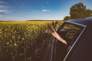 Yaz eğlencesi eski model araba. Kas arabadan gösterilen bacaklar. Özgürlük, seyahat ve tatil road trip kavramı yaşam tarzı görüntü