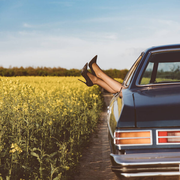 High heels shoes out of car window