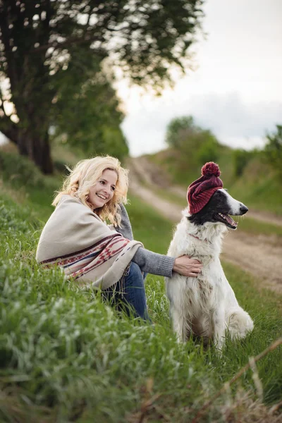 Young woman and her dog outdoor — Stock Photo, Image
