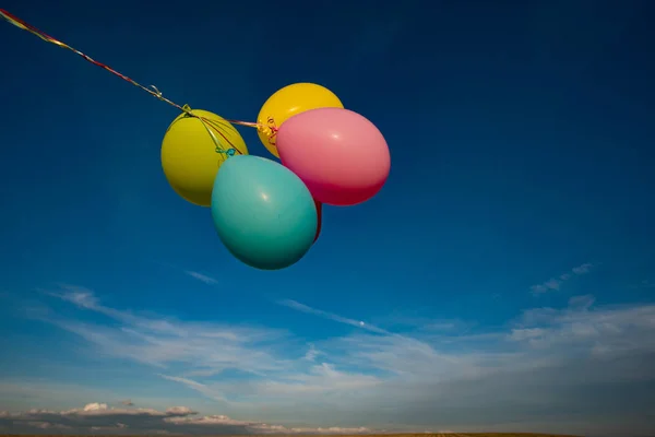 Colourful toy ballons and blue sky — Stock Photo, Image