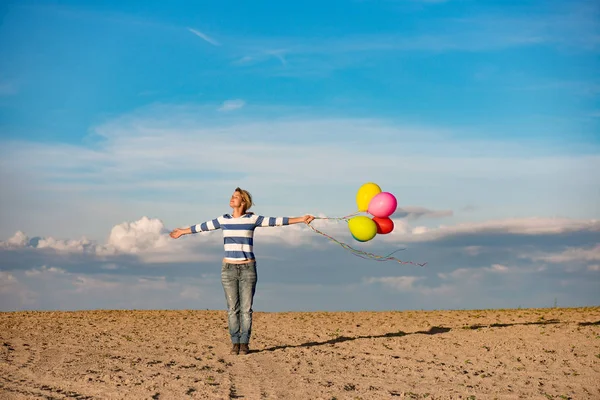 Young woman with toy balloons — Stock Photo, Image