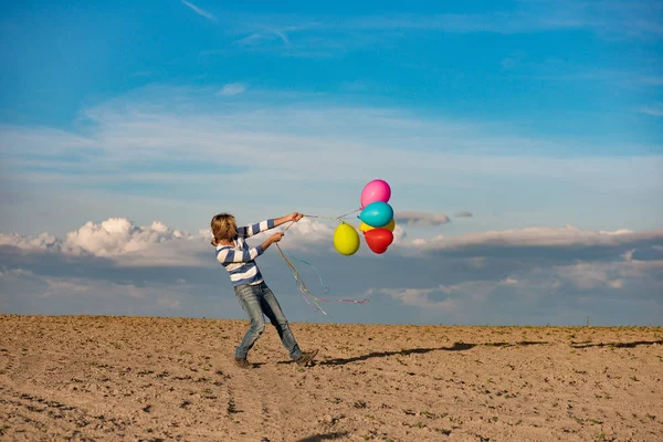 Birthday girl with colourful balloons outdoors — Stock Photo, Image