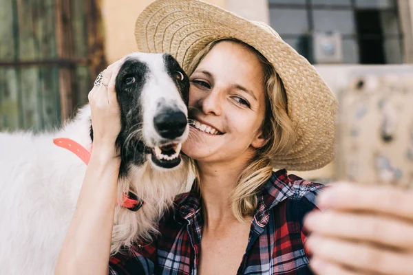 Joven mujer tomando autorretrato ingenio su perro para social media perfil foto — Foto de Stock