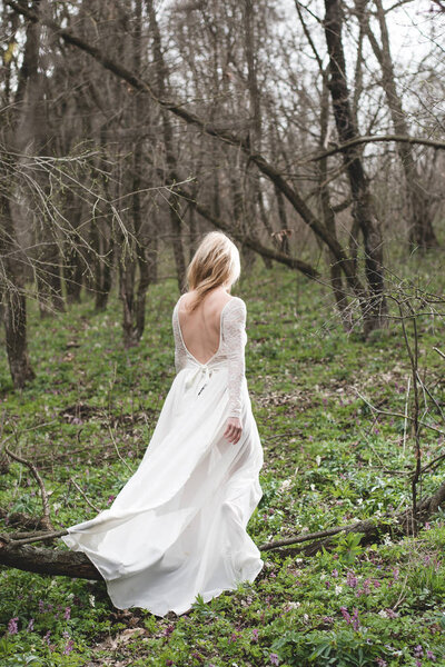 Beautiful bride walking in forest